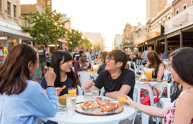 Students enjoying pizza on Rundle Street, Adelaide, South Australia