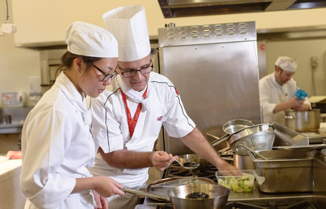 A chef teaching a student